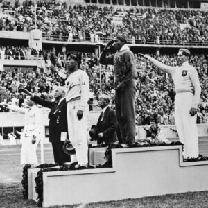 Jesse Owens on the podium at the 1936 Berlin Olympics